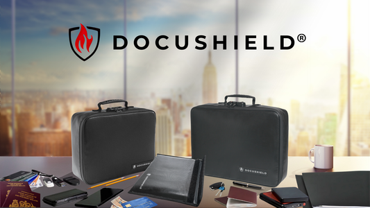 Three DocuShield fireproof document storage cases displayed on a desk, with various everyday essentials such as passports, USB drives, smartphones, and office supplies, against a city skyline backdrop.